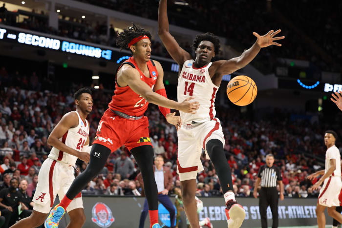 Maryland Terrapins guard Ian Martinez (23) and Alabama Crimson Tide center Charles Bediako (14) chase a rebound during the first half at Legacy Arena.